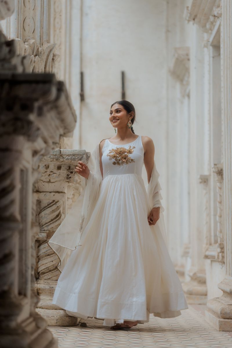 SHYAMAL & BHUMIKA - A beautiful ivory gown that draws inspiration from  fairytales and dreams. It is intricately embroidered with monotone floral  applique and thread embroidery on tulle and embellished with sequins,